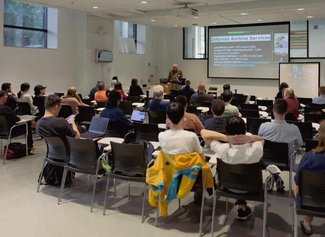 Picture of a group of people sitting listening to a presentation at a Civic Tech Toronto Hacknight